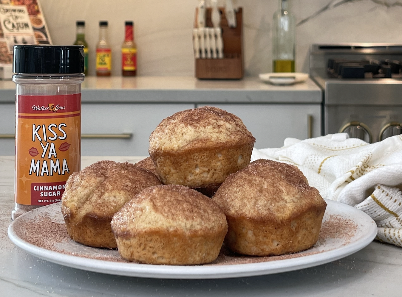Cinnamon muffins with bottle of Kiss Ya Mama Cinnamon Sugar